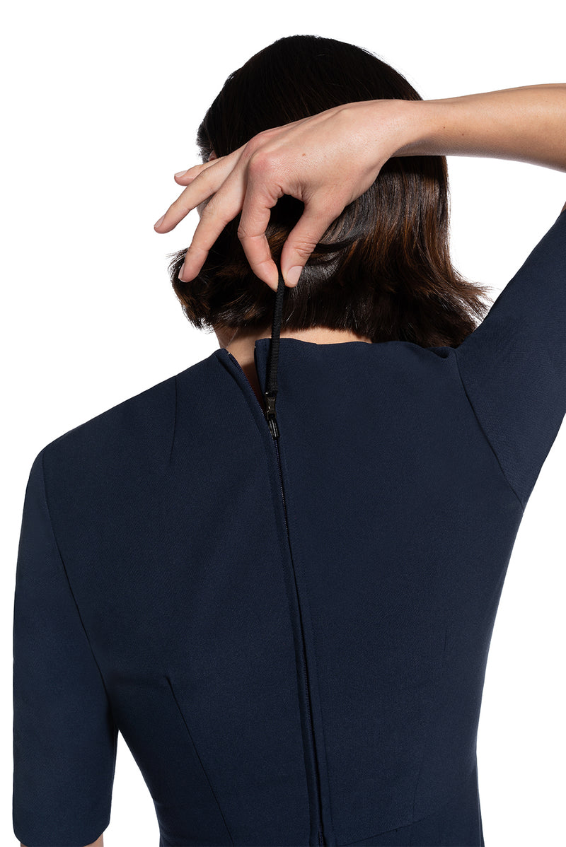 close-up back view of re-engineered zipper on woman 1 wearing the navy alpha dress not your average navy collection